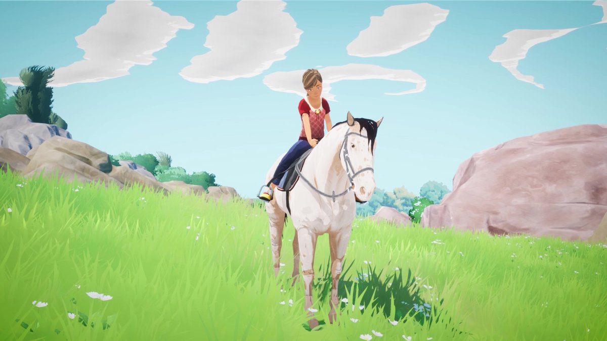 Uma garota sentada em um cavalo em um prado